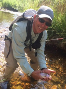 Angler holding trout at water's surface
