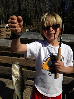 Young angler with largemouth bass