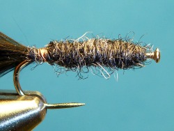 Black Killer Bugger tied on a bent pin, in the vise.