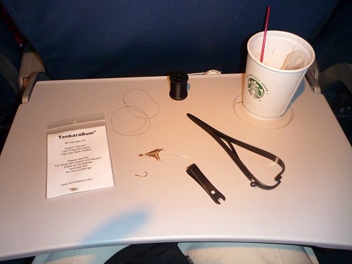 Airline tray table with fly tying implements