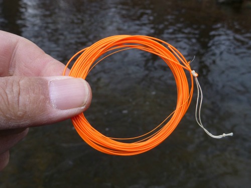 Fujino Orange Tenkara Line with river water in background