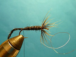Yarn wrapped to bend, back to hackle, again to bend.