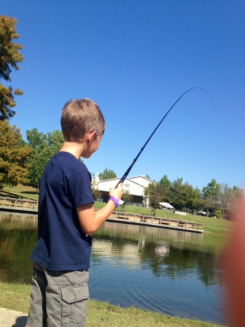 Child fishing in lake.