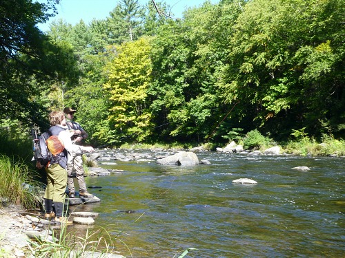 Two anglers at the side of a rocky river
