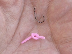 Overhand knot tied in pink chenille.