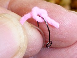 Hook being inserted in the loop of the overhand knot before tightening