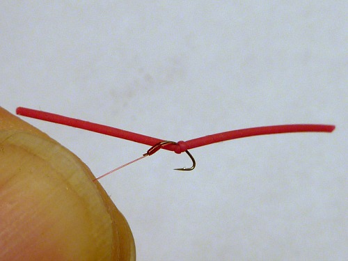 Overhand worm tied with panfish popper leg material on a tanago hook