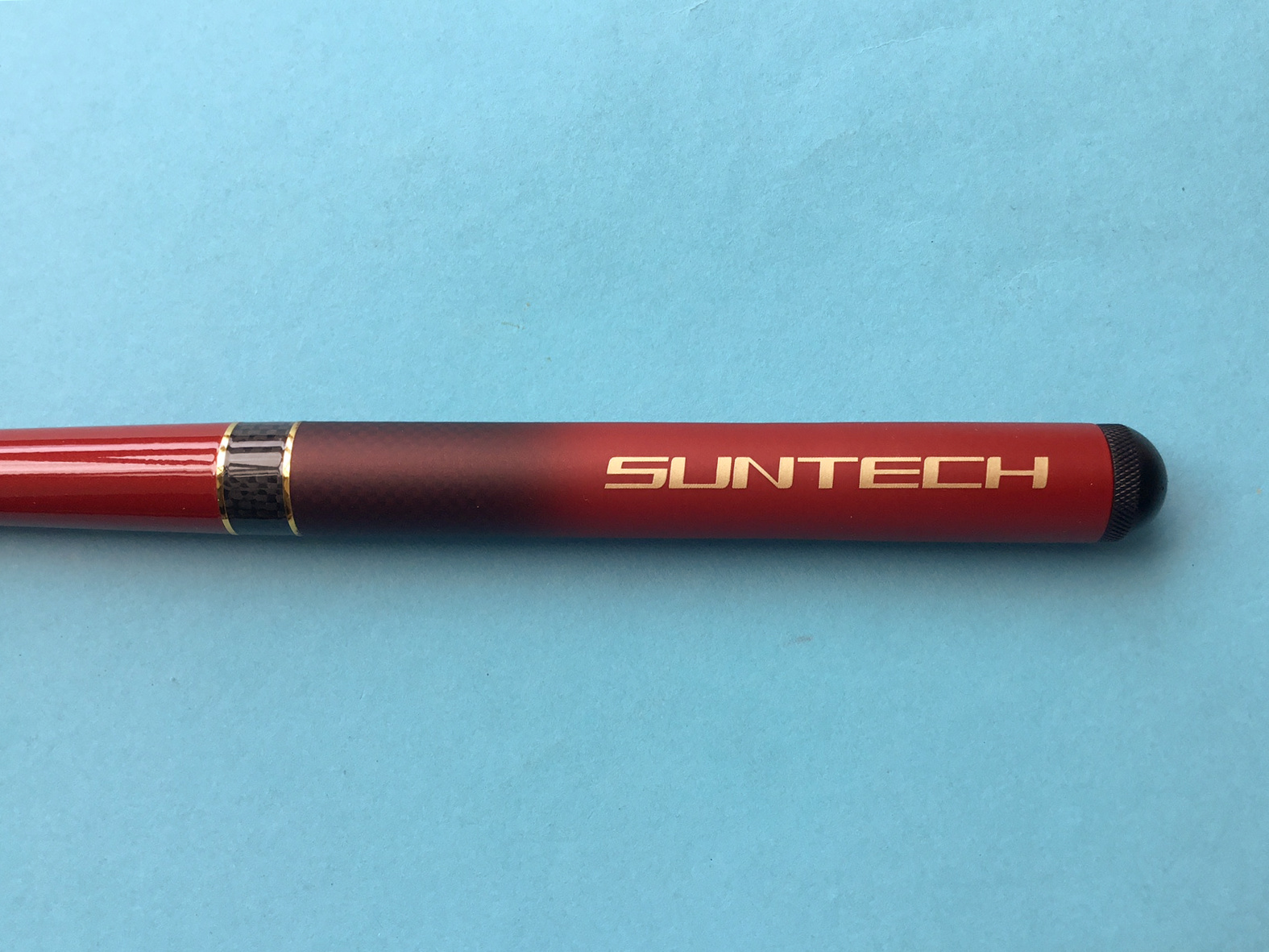 Suntech Kurenai PROSPEC 33 Grip showing SUNTECH name in bold gold print.