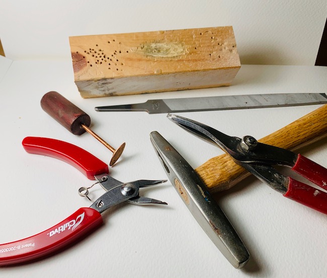 Tools of the trade: hammer, shears, split ring pliers, wood block, file