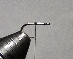 Hook in vise, thread started in middle of shank