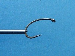 Daiwa Figure 8 tool's hook holding a size 6 hook tight against the end of the barrel.