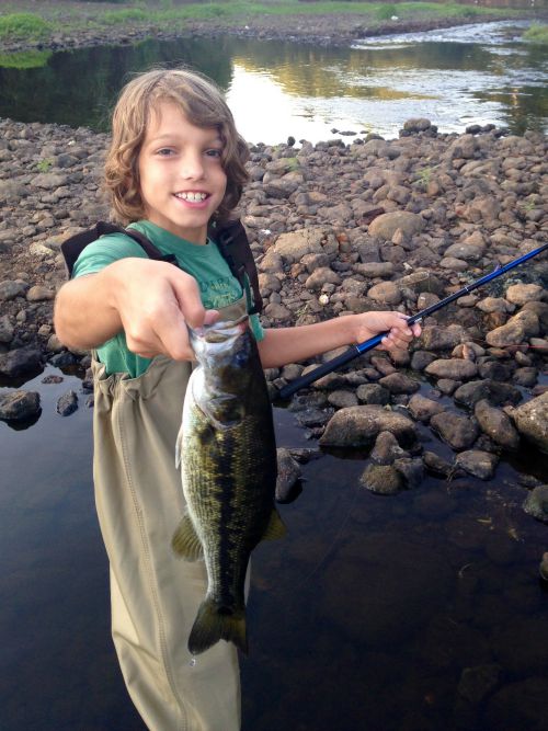 Young angler holding largemouth bass