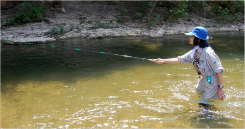 Slide: Photo of Misako Ishimura fishing with her rod nearly horizontal.