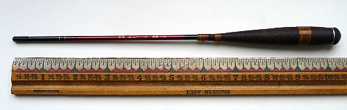 Collapsed Nissin Tanago Koro rod alongside ruler for scale, showing that it is about 10 inches long.