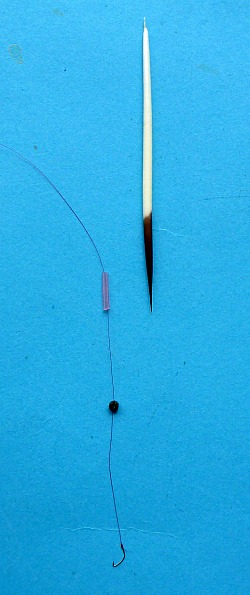 Porcupine quill, line through short piece of tubing, shot and hook