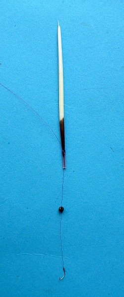 Quill inserted into piece of tubing, holding line so it won't slide.