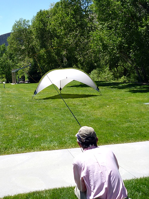 Slide: Photo of Tenkara no Oni casting a 10 meter line so that it lands under a sun tent.