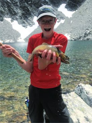 Young angler showing off cutthroat trout